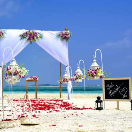 Beachside Wedding Arch Set with White Drapes and Floral Decor